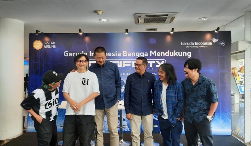 Personel Band Gigi bersama Dirut Garuda Indonesia Irfan Setiaputra dan Direktur Niaga Garuda, Ade R Susardi saat konferensi pers persiapan konser Giginfinity 30th Anniversary di Kantor Garuda, Selasa (6/8/2024).